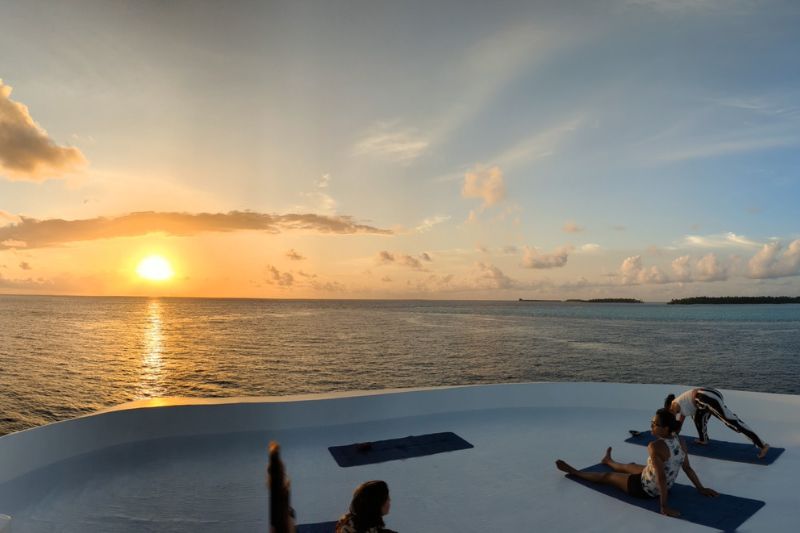 Maldives yoga retreat liveaboard sundeck sunset yoga cynthia travels